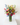 Bouquet of colorful flowers in a clear vase on a white surface with a white background