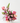 Bouquet of pink and purple flowers in a white vase on a white surface with a white background