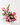 Bouquet of pink and purple flowers in a white vase on a white surface with a white background
